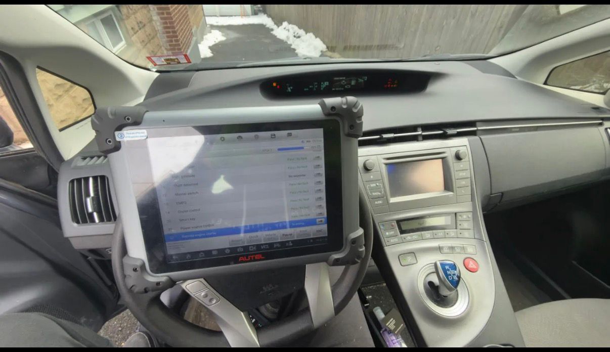 Diagnostic tablet connected inside a Toyota Prius